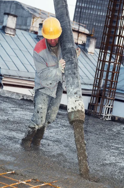 Работник строитель бетонирования в форму — стоковое фото